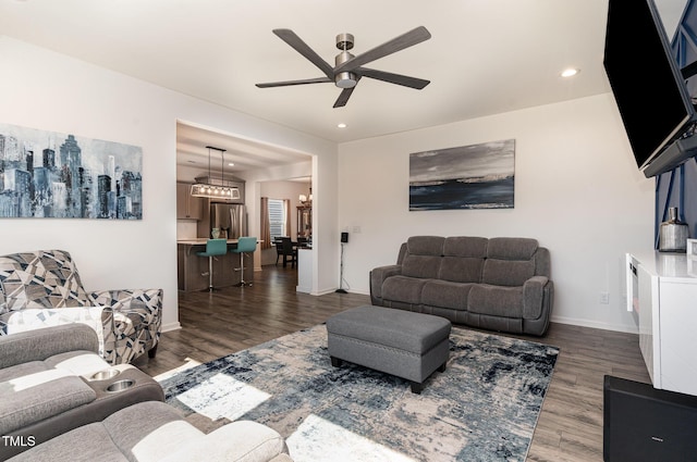 living area featuring recessed lighting, dark wood-type flooring, and a ceiling fan