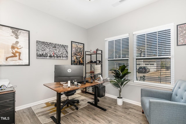 office area featuring wood finished floors, visible vents, and baseboards