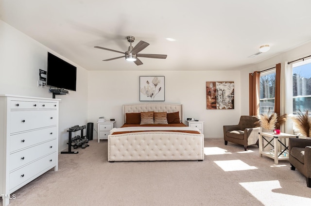 bedroom with a ceiling fan and carpet