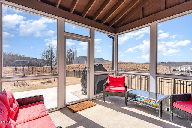 sunroom / solarium featuring lofted ceiling