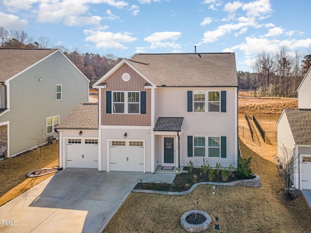 traditional-style home featuring board and batten siding, driveway, and a shingled roof