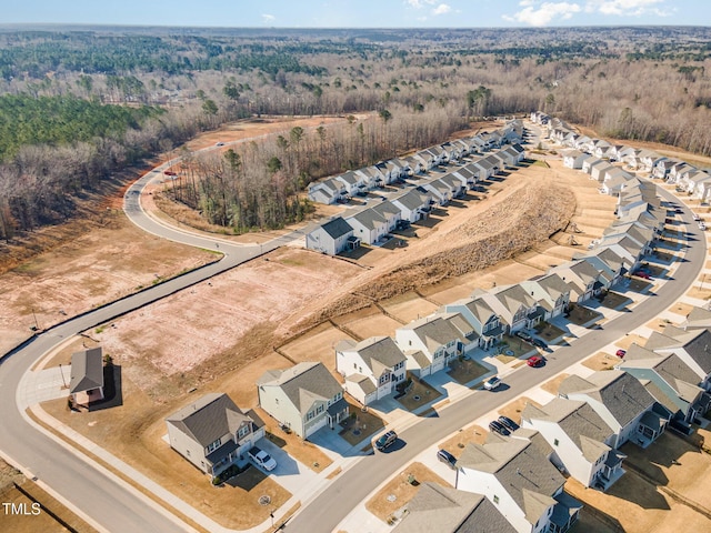 aerial view featuring a forest view and a residential view