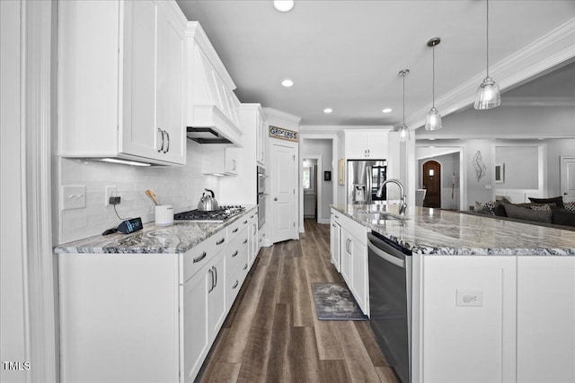 kitchen with dark wood-style flooring, a sink, white cabinetry, ornamental molding, and appliances with stainless steel finishes