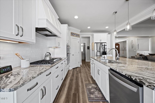 kitchen featuring stainless steel appliances, premium range hood, a sink, and crown molding