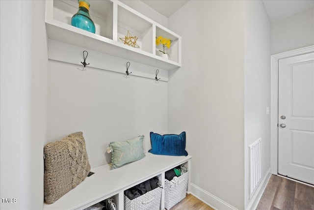 mudroom featuring wood finished floors, visible vents, and baseboards