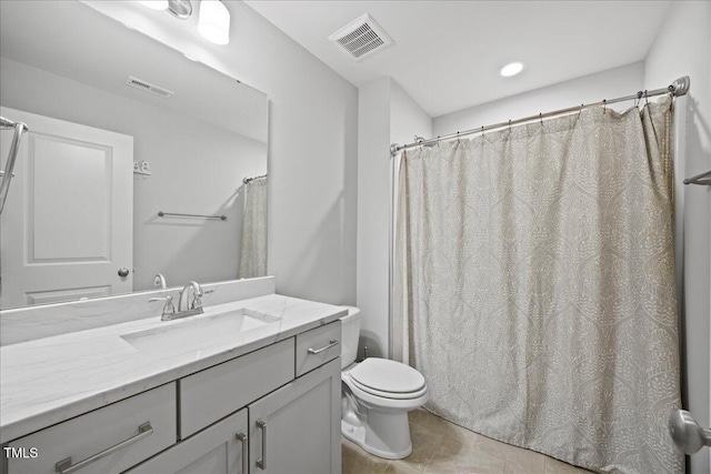 bathroom featuring visible vents, vanity, toilet, and tile patterned floors