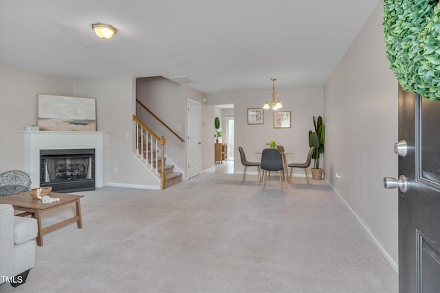 interior space featuring an inviting chandelier, baseboards, a fireplace, and stairway