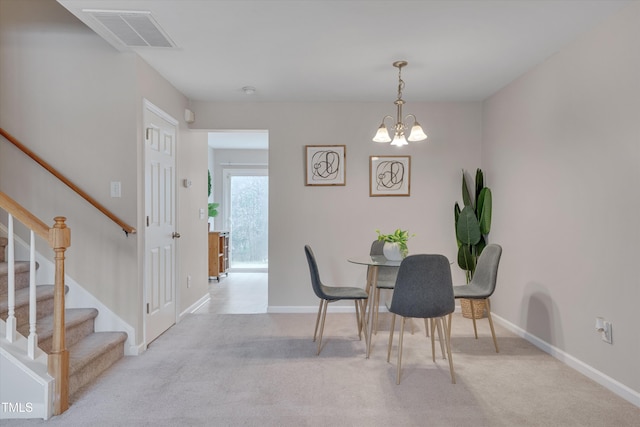 dining space with stairs, carpet flooring, visible vents, and an inviting chandelier