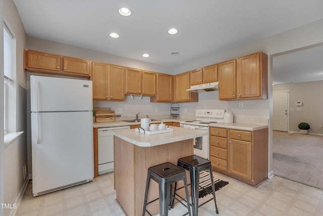 kitchen featuring light floors, recessed lighting, a sink, white appliances, and under cabinet range hood