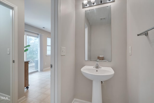 bathroom featuring baseboards, visible vents, and tile patterned floors