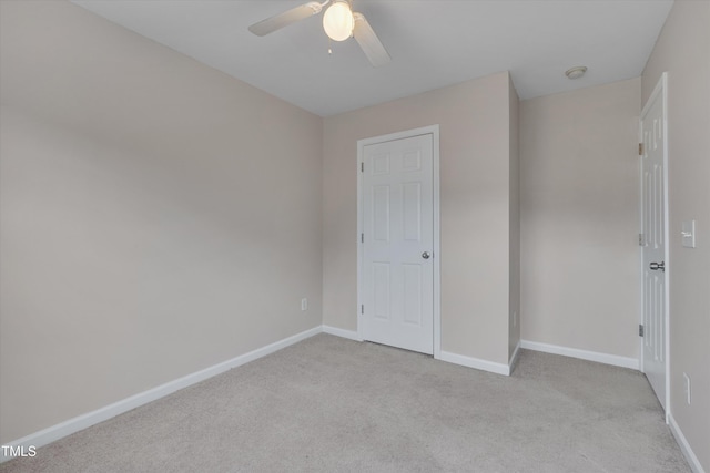 unfurnished bedroom featuring baseboards, ceiling fan, and light colored carpet