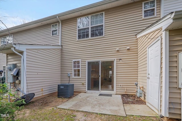 back of house featuring a patio area and central air condition unit