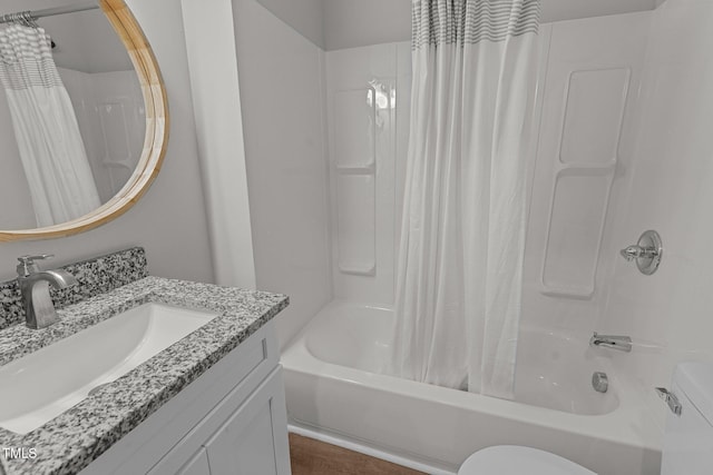 bathroom with shower / tub combo, vanity, and toilet