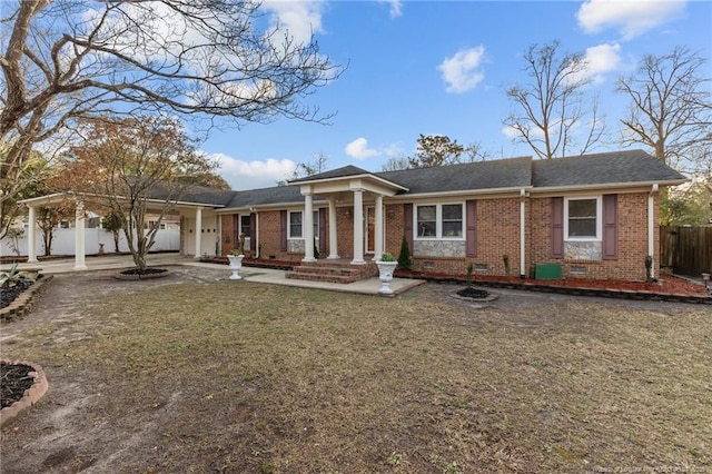 view of front of house featuring an attached garage, brick siding, fence, driveway, and crawl space