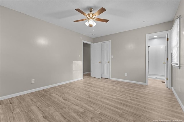unfurnished bedroom with light wood-style floors, baseboards, and a ceiling fan