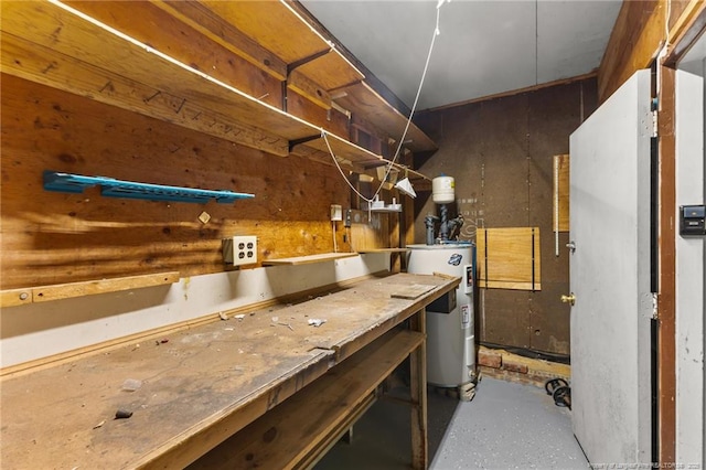 basement with water heater and a workshop area