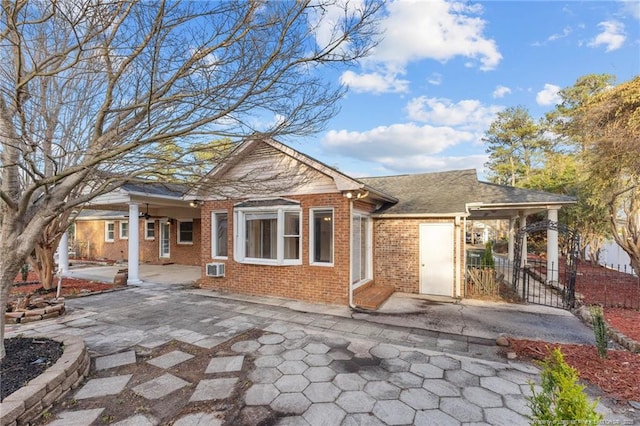 view of front of home with a patio and brick siding