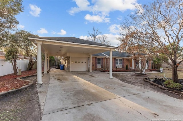 ranch-style house with driveway, a garage, an attached carport, fence, and brick siding