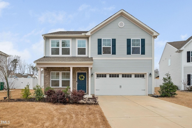 traditional-style house with a garage, concrete driveway, brick siding, and fence