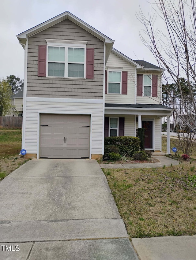 traditional-style home featuring a garage and concrete driveway