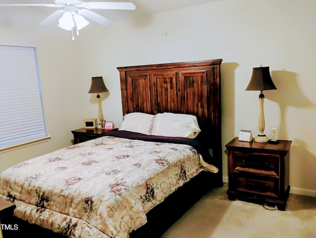 bedroom with a ceiling fan, light colored carpet, and baseboards