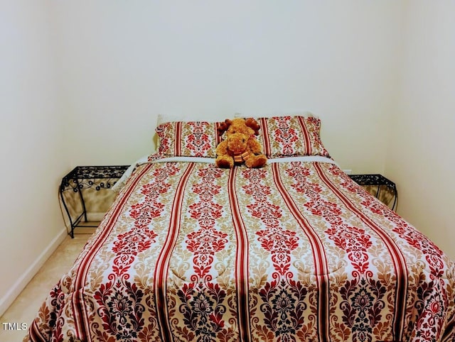 bedroom with light carpet and baseboards