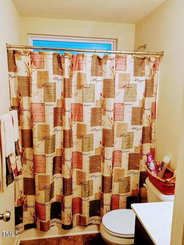 bathroom with toilet, curtained shower, vanity, and tile patterned floors