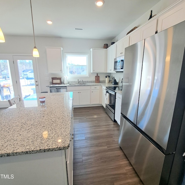 kitchen with dark wood-style floors, stainless steel appliances, a sink, and white cabinets