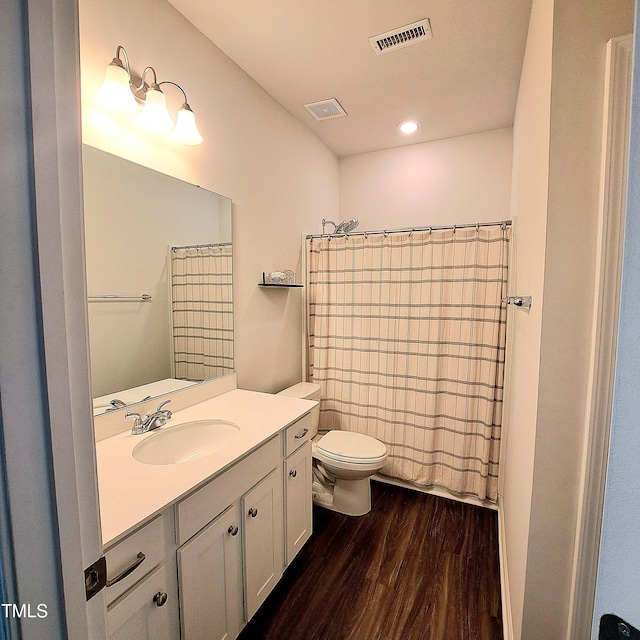 full bathroom featuring visible vents, vanity, toilet, and wood finished floors