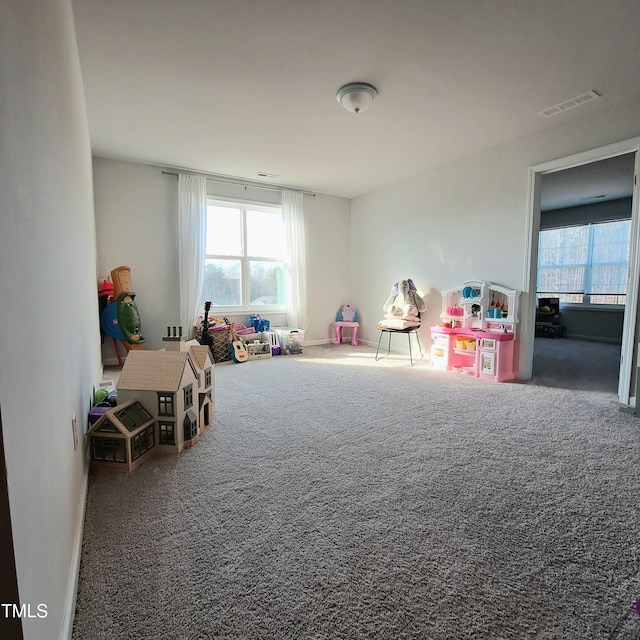 playroom with carpet floors, a wealth of natural light, and visible vents