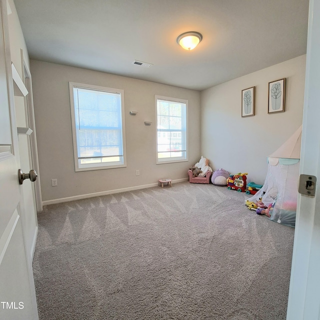 playroom with baseboards, visible vents, and carpet flooring