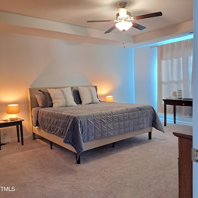 carpeted bedroom with ceiling fan and baseboards