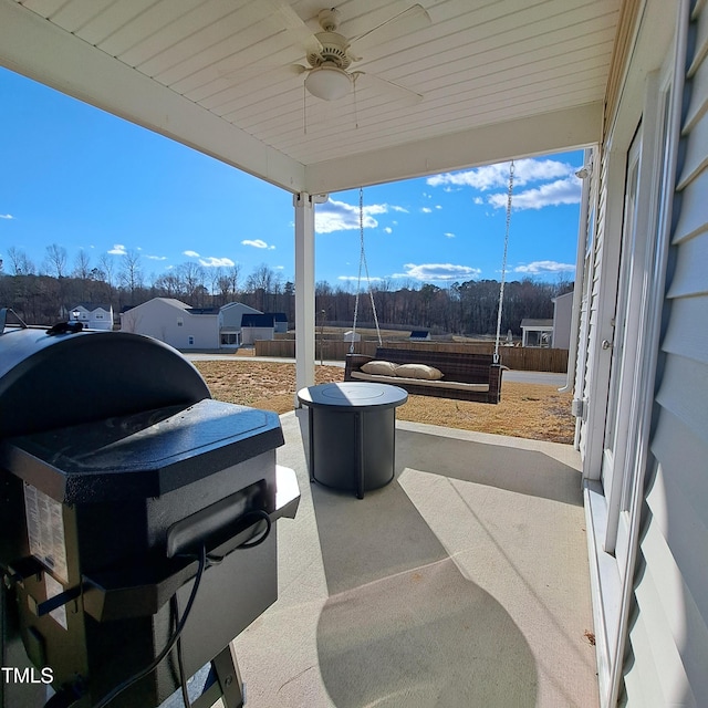 view of patio with a grill, fence, and a ceiling fan