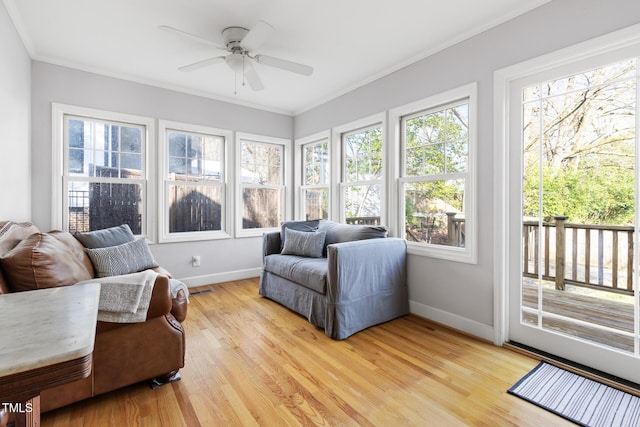 sunroom / solarium featuring a ceiling fan