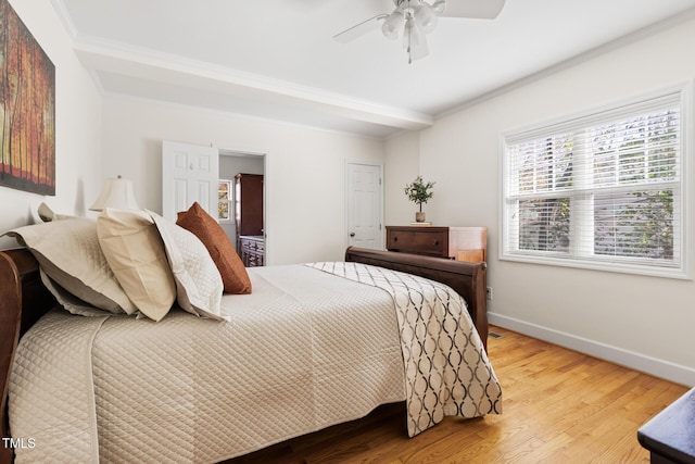 bedroom with ceiling fan, ornamental molding, wood finished floors, and baseboards