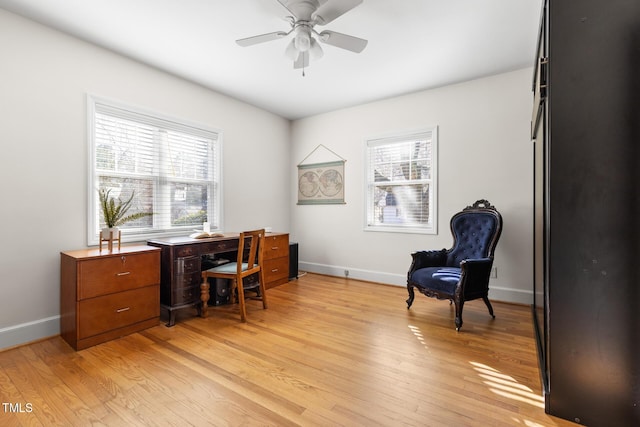 office featuring light wood-style floors, baseboards, and a ceiling fan