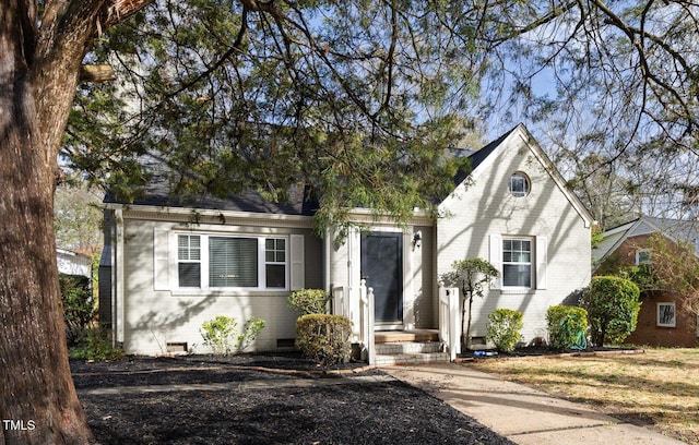 view of front of property with brick siding and crawl space