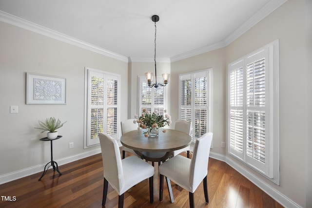 dining room featuring dark wood-type flooring, a chandelier, ornamental molding, and baseboards