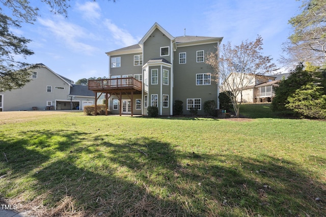 back of house featuring central AC, a deck, and a lawn