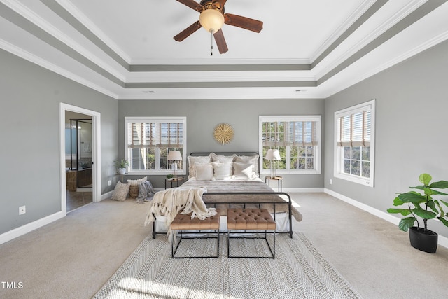 carpeted bedroom with a raised ceiling, multiple windows, crown molding, and baseboards