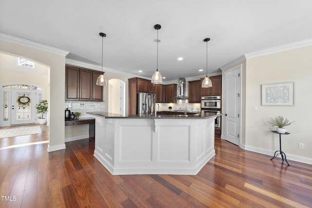 kitchen featuring arched walkways, stainless steel appliances, dark wood-type flooring, wall chimney range hood, and dark brown cabinets