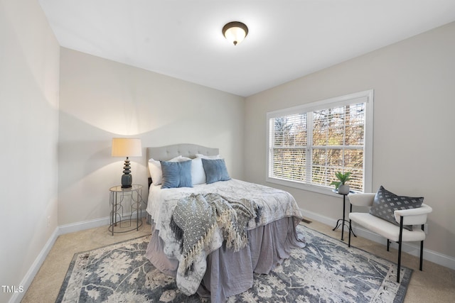 bedroom featuring carpet and baseboards