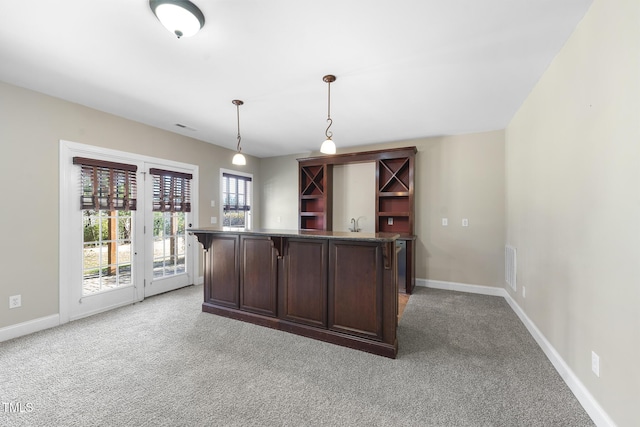 kitchen with light carpet and baseboards