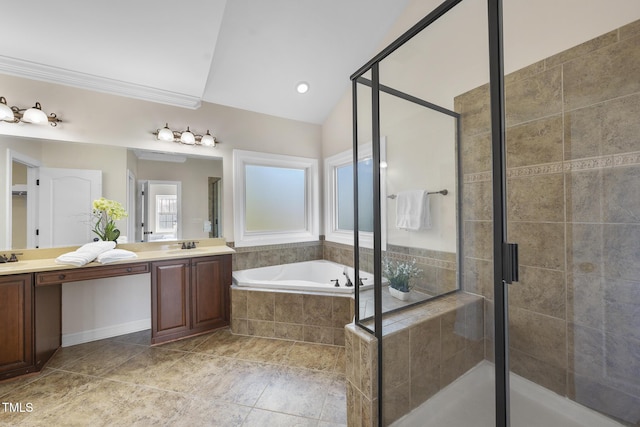 bathroom with vaulted ceiling, double vanity, a stall shower, and a garden tub