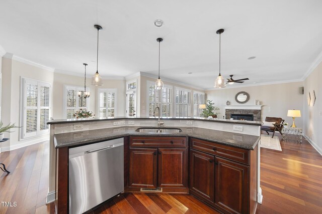 kitchen with dishwasher, a fireplace, a sink, and dark wood finished floors