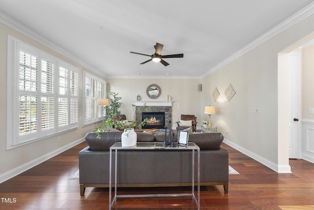 living room with ceiling fan, a fireplace, baseboards, and wood finished floors