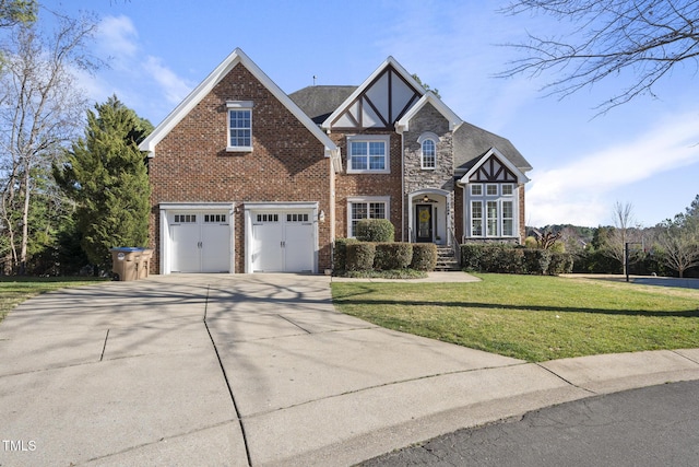 tudor house featuring concrete driveway, brick siding, an attached garage, and a front lawn