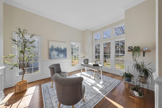 office area featuring ornamental molding, a wainscoted wall, a decorative wall, and hardwood / wood-style flooring