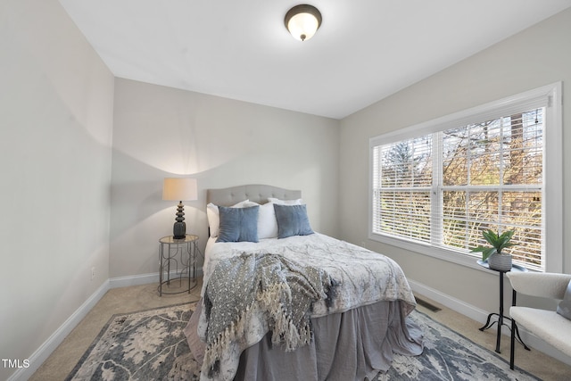 bedroom with carpet floors, visible vents, and baseboards