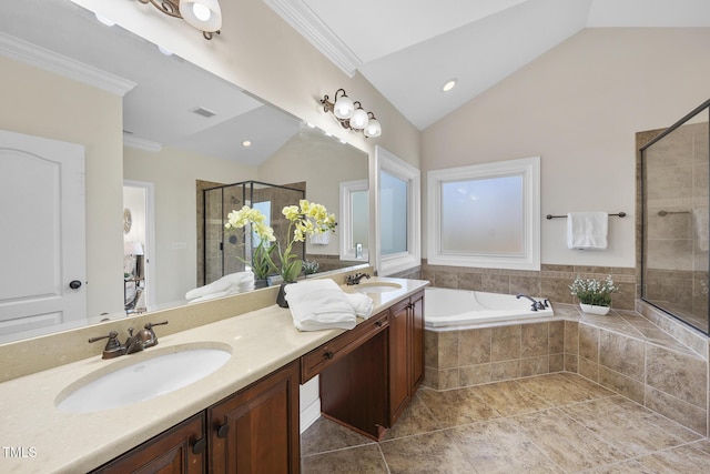 full bathroom with a bath, a shower stall, vaulted ceiling, and a sink